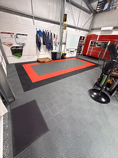 Custom Swisstrax garage floor with red, black and gray tile design