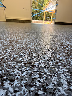 Close-up of gray decorative flake concrete floor coating